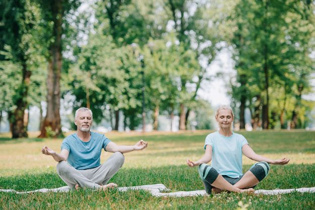 mature man woman meditating Mature man and woman meditating