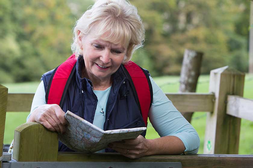 Active Senior Woman On Walk In Countryside