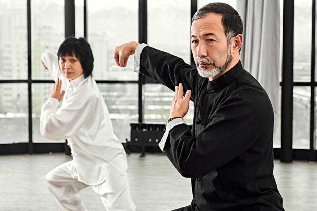 Couple of senior masters practicing qi qong taijiquan