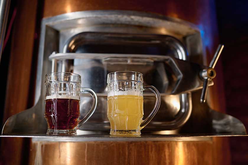 Freshly made craft light dark beer glass mug standing barrel Freshly made craft light dark beer glass mug standing barrel