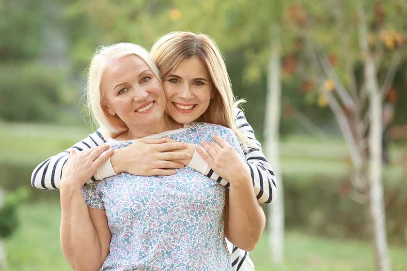 Young woman with elderly mother outdoors