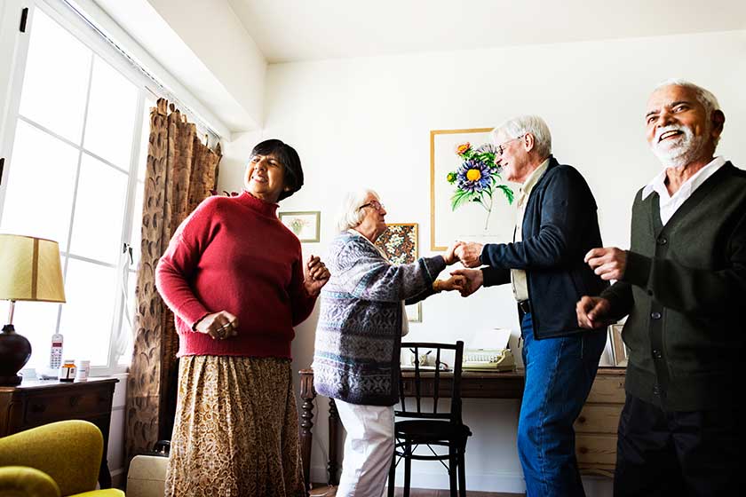 Senior friends dancing together home Senior friends dancing together home