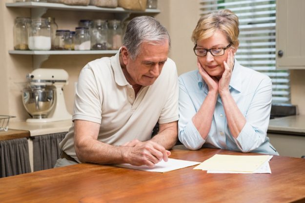 Senior couple working out their bills at home in the kitchen 10 Tips To Plan For A New Life In Independent Living Apartments In Oak Park, AR As A Veteran