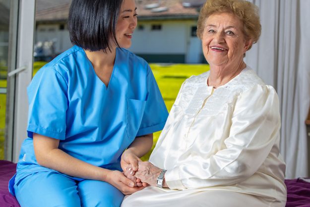 caucasian female senior smiling nurse rehab clinic retired elderly people