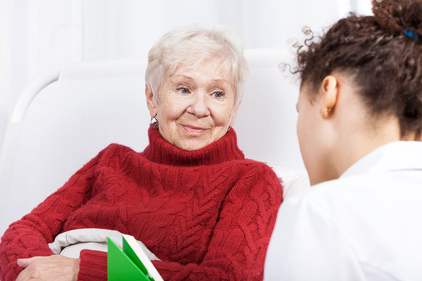 elderly lady listening to nurse