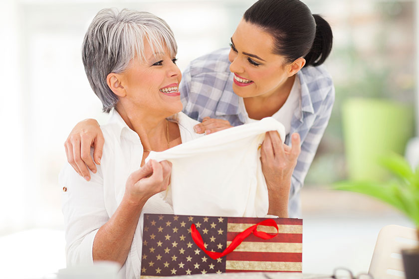 Excited middle aged mother looking at her gift Excited middle aged mother looking at her gift