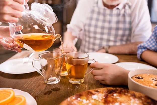 Family drinking tea at home