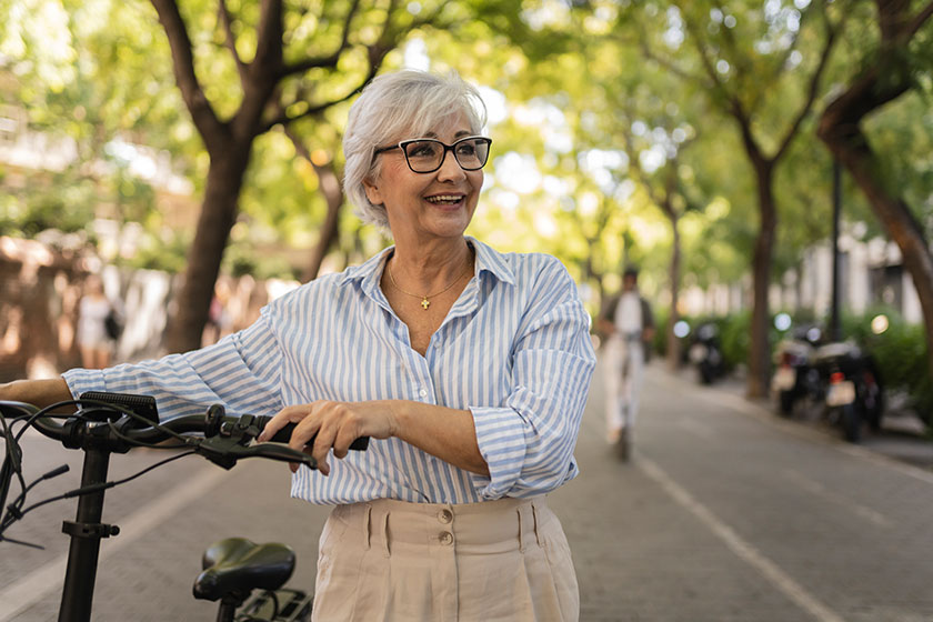 happy gray hair mature woman mature walking bicycle city