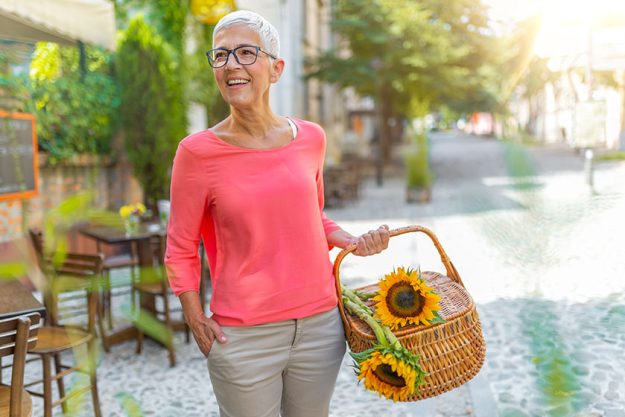 happy senior woman carrying baskets fresh sunflowers old age retirement happy senior woman carrying baskets fresh sunflowers old age retirement