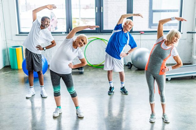High angle view multiethnic senior sportspeople synchronous exercising