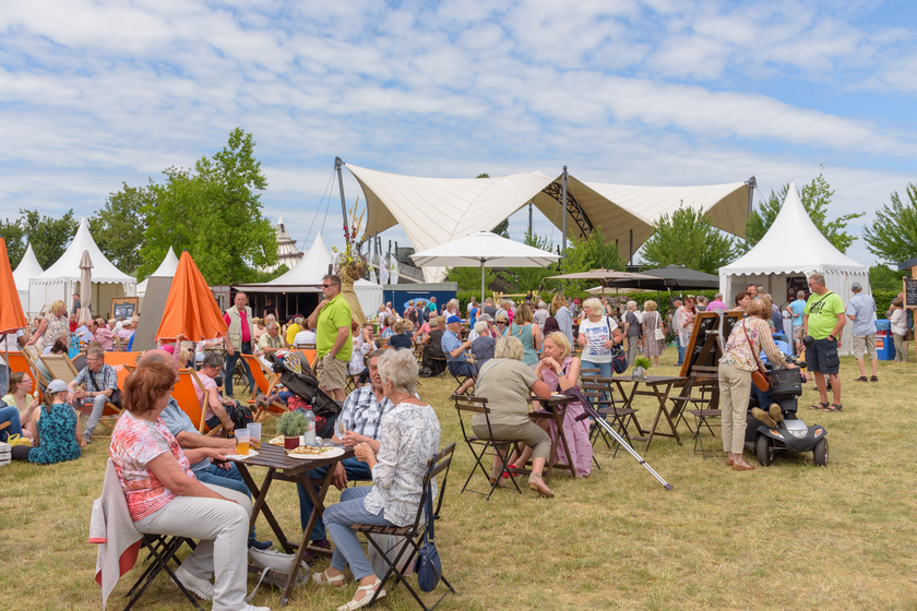 Magdeburg, Germany – June 11, 2022: People sit at tables in an open-air cafe Retiring In Houston, TX: 5 Summer Seasonal Events You Can Explore