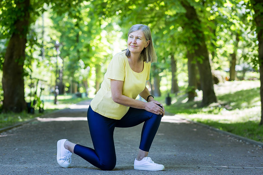 Senior active woman on a jog injured her leg and knee, gray