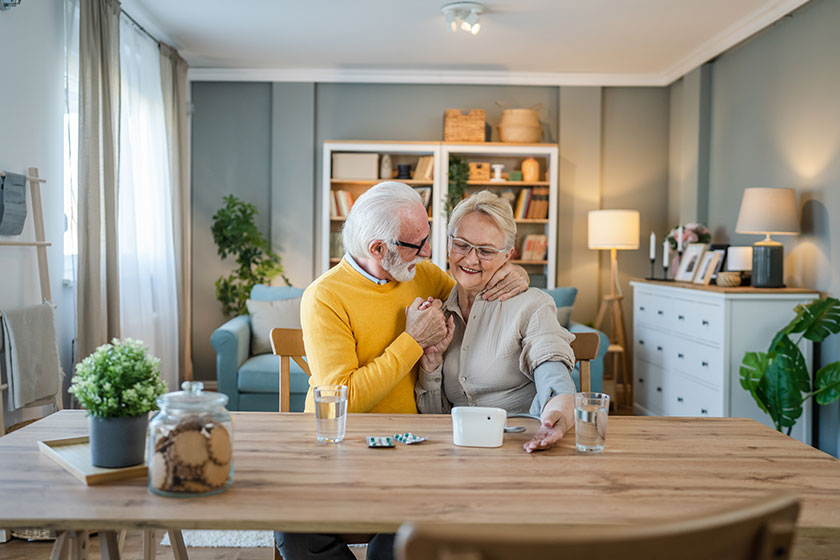 senior couple woman check measure blood pressure while her husband