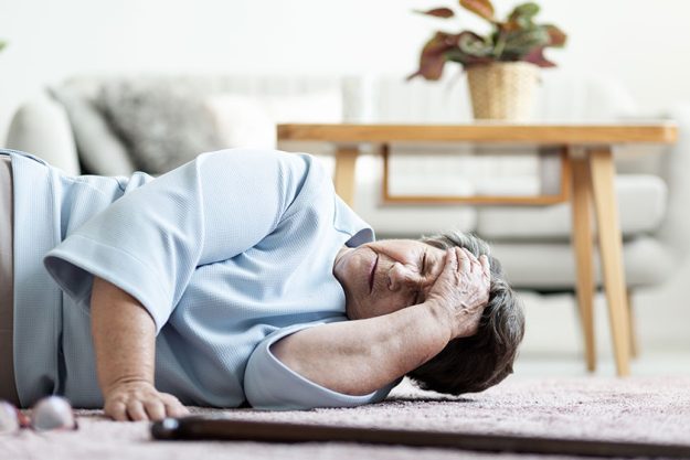 senior woman headache falling home