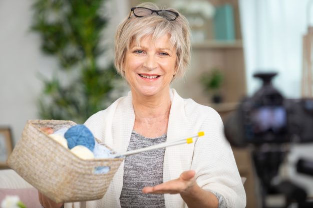 confident senior fashion designer in her workshop