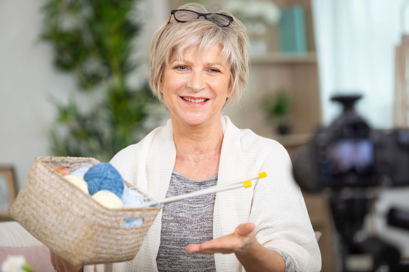 confident senior fashion designer in her workshop