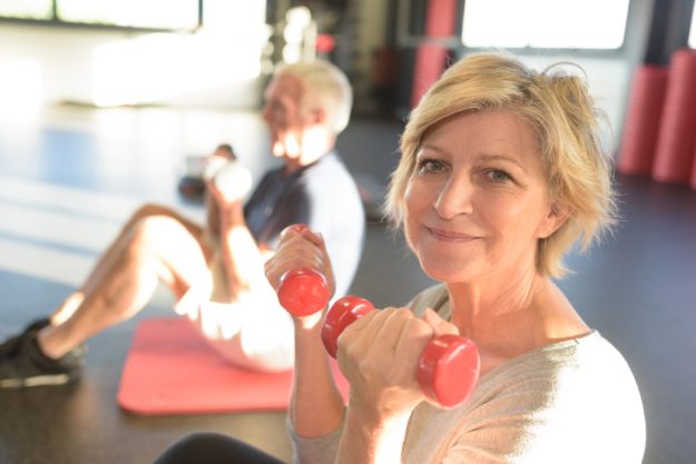 portrait of senior woman lifting dumbbells The Importance Of Adjusting To A New Life In Assisted Living Apartments In Arlington, TX After A Stroke