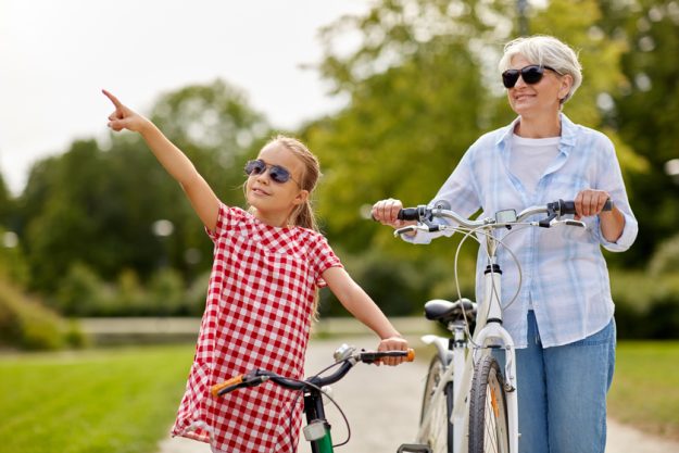 grandmother and granddaughter with bicycles Why Walkability Matters When Selecting A Senior Living Community Location