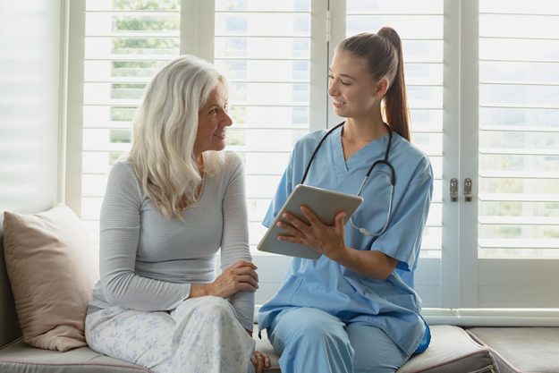 Front view active senior caucasian woman female doctor using digital