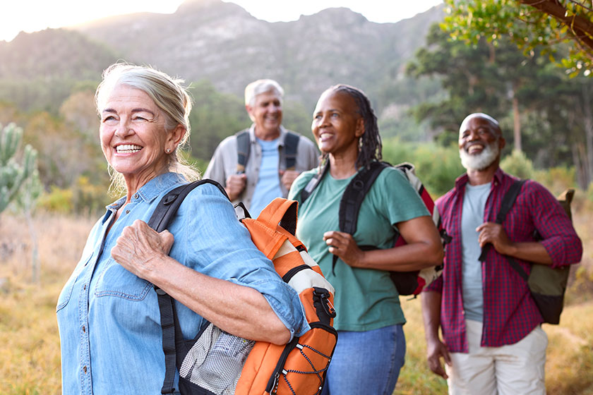 Group senior friends enjoying hiking countryside together