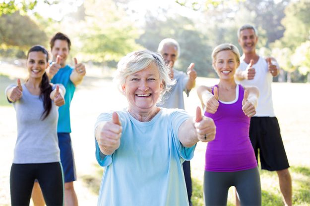 Happy athletic group with thumbs up