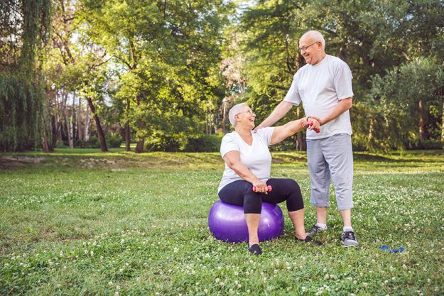 Happy mature family couple exercising outdoors