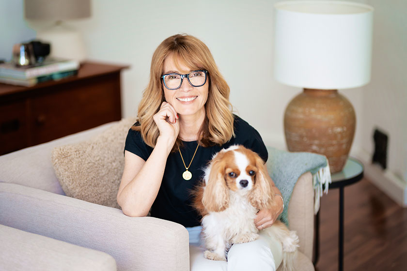 Happy middle aged woman relaxing home armchair her cute puppy Happy middle aged woman relaxing home armchair her cute puppy