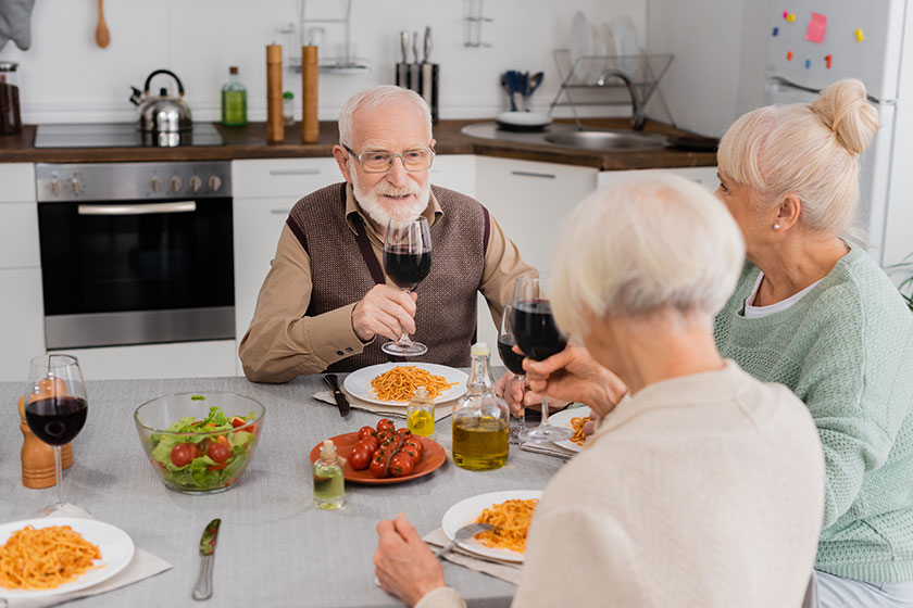 Happy senior man clinking glasses red wine retired women tasty Happy senior man clinking glasses red wine retired women tasty