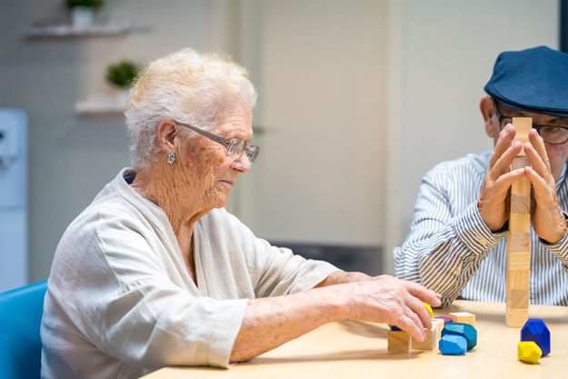 Old woman man nursing home playing skill games