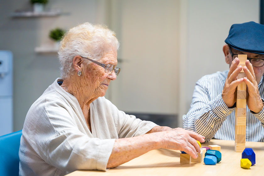 Old woman man nursing home playing skill games Old woman man nursing home playing skill games
