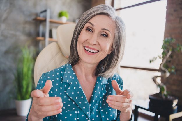 Photo of charming happy old woman point fingers