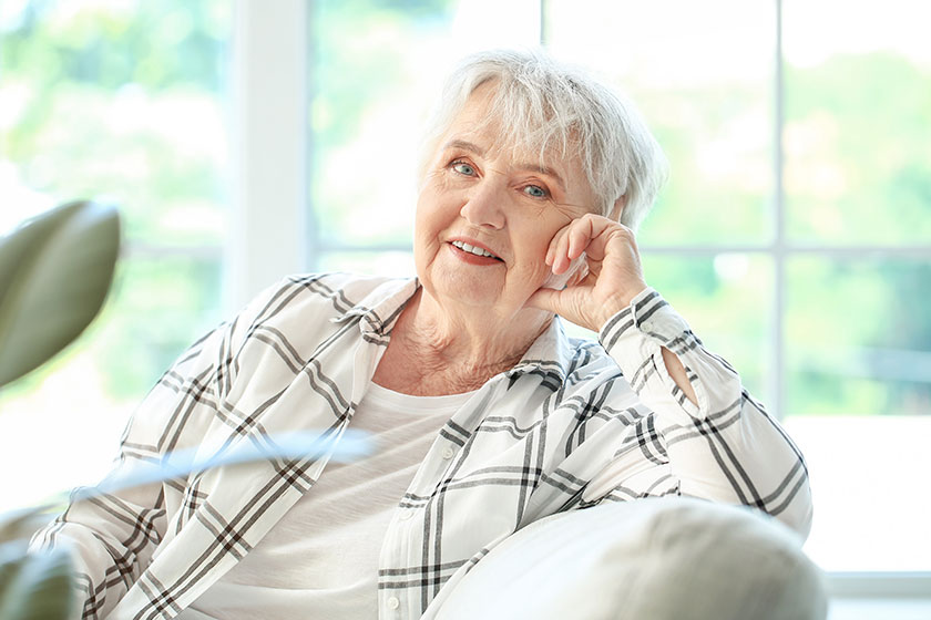 Senior woman sitting sofa home
