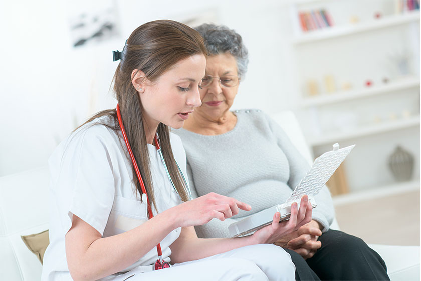 Smiling elderly lady with her supportive doctor