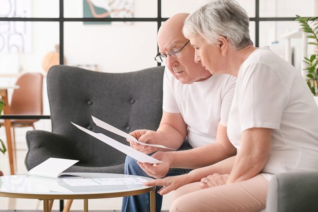 Stressed senior couple in debt at home