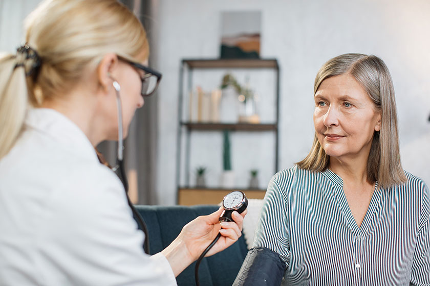 Close up photo of blood pressure measurement blurred view of female nurse or doctor doing
