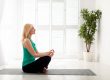 peaceful mature lady meditating home sitting lotus position closed eyes