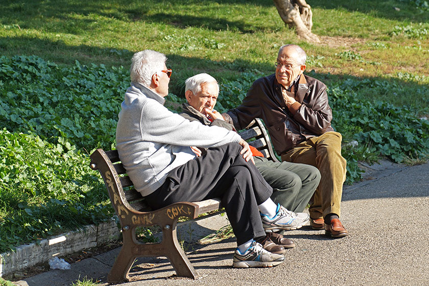 Rome italy 20 november 2015 conversation three old men conversing sitting on a bench in