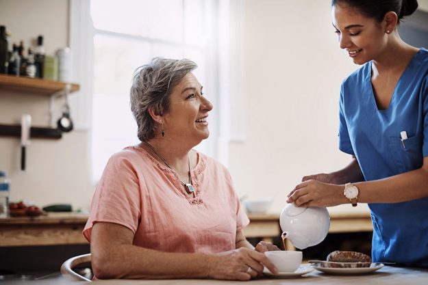 time some afternoon tea attractive young female caregiver pouring cup