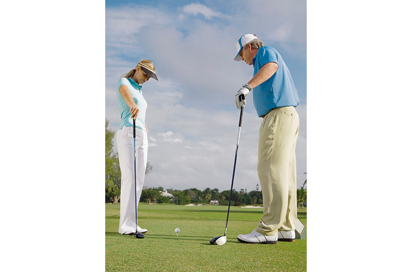 senior couple playing golf course