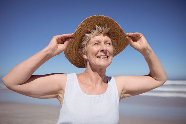 senior woman wearing sun hat
