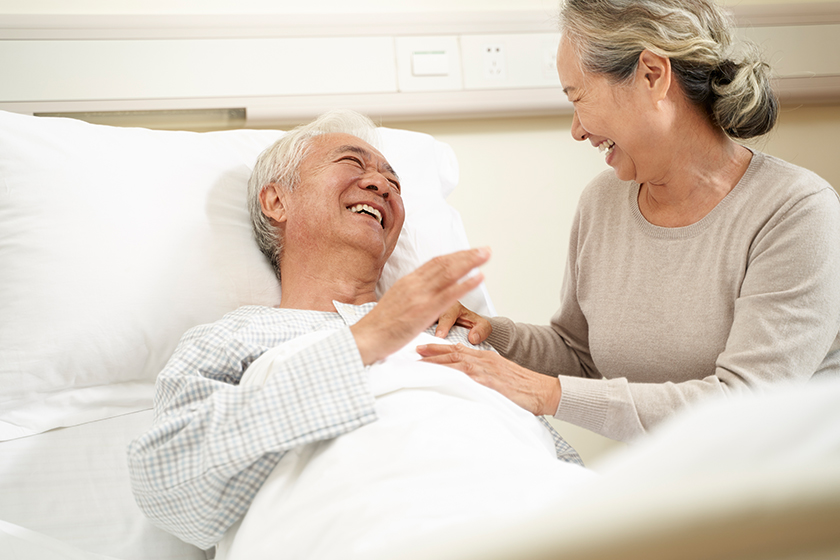 asian senior woman visiting husband in hospital