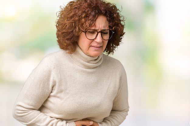 beautiful middle ager senior woman wearing turtleneck sweater glasses isolated