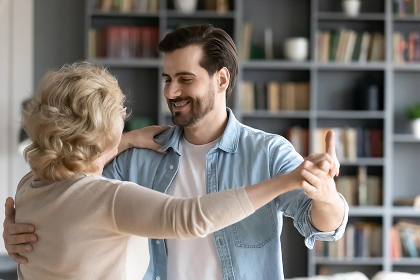 close up smiling adult son dancing with mature mother close up smiling adult son dancing with mature mother