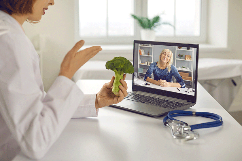 doctor video calling senior patient on laptop and giving her healthy diet advice doctor video calling senior patient on laptop and giving her healthy diet advice