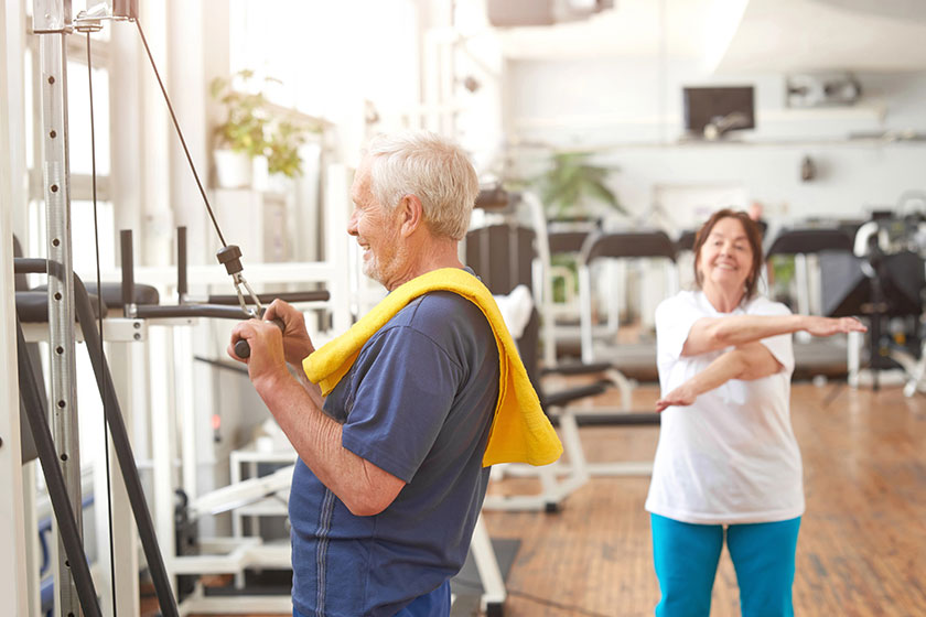 Elderly man working out at fitness center