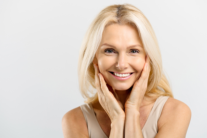 enchanting-middle-aged-woman-with-blonde-hair-hug-herself-and-look-at-the-camera.jpg