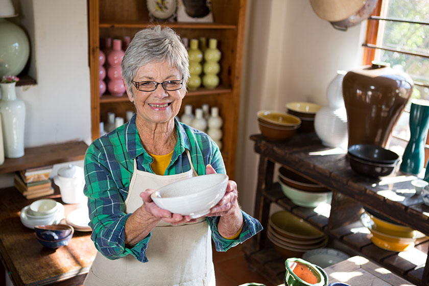 female potter holding bowl