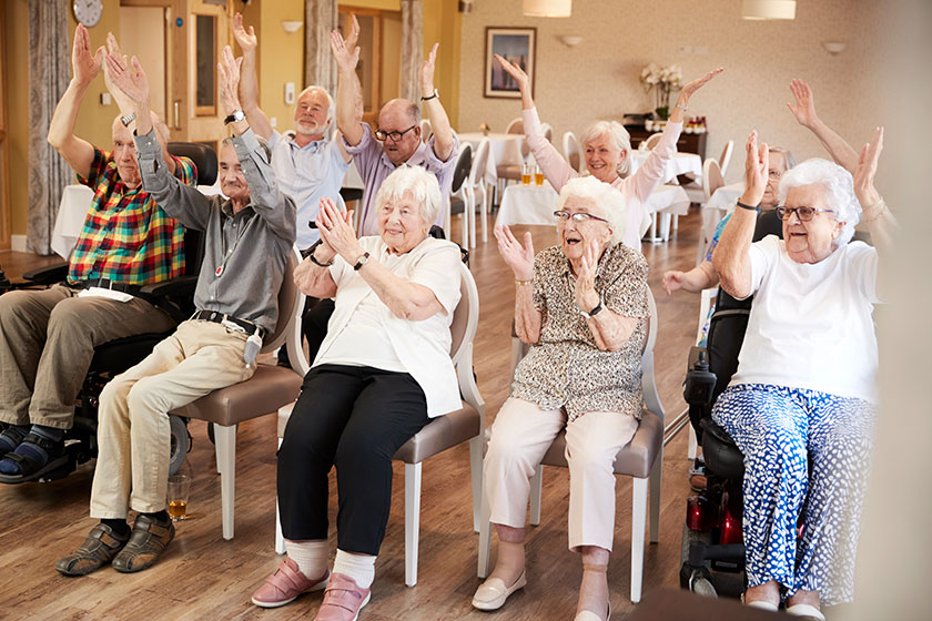 group seniors enjoying fitness class retirement home