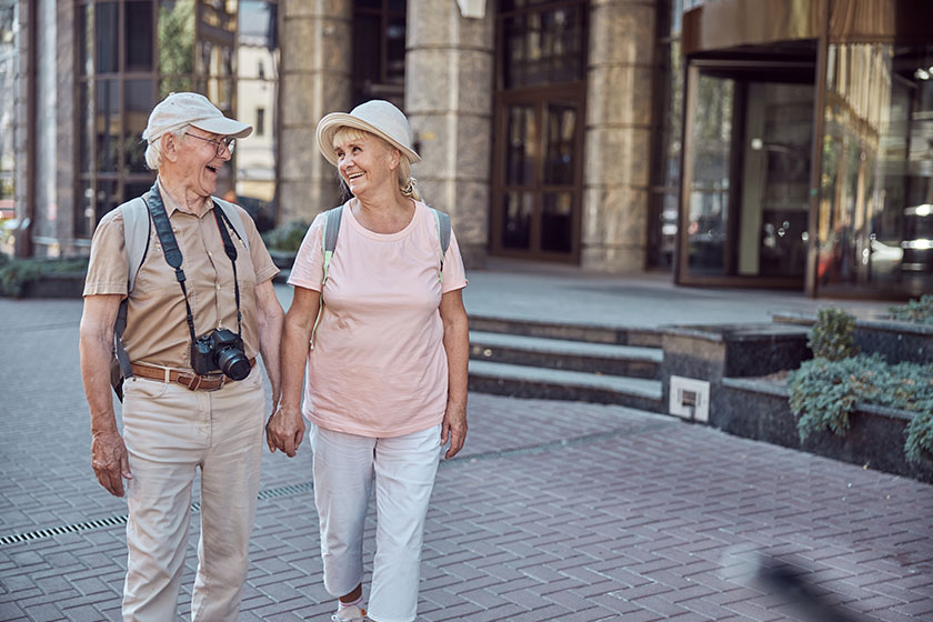 man with a digital camera looking at his wife