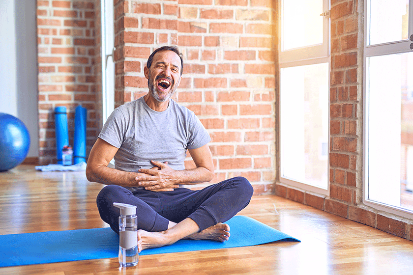 middle age handsome sportman sitting mat doing stretching yoga exercise middle age handsome sportman sitting mat doing stretching yoga exercise